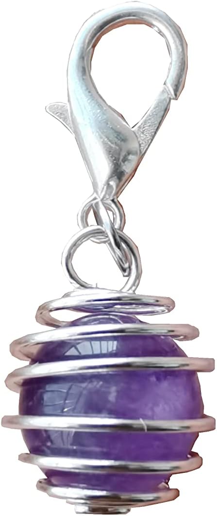 DogTrust holistic pet collar charms used as a stylish crystal protection keychain accessory on a travel backpack
