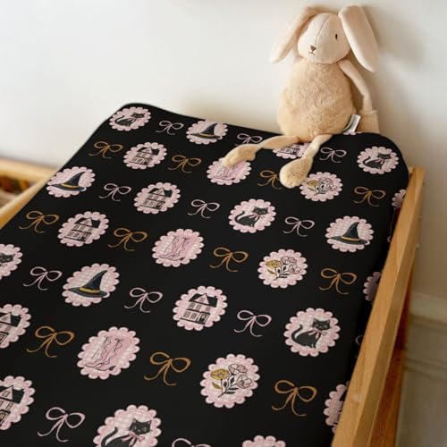 Side view of fitted Halloween changing table cover on standard pad