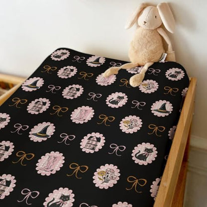 Side view of fitted Halloween changing table cover on standard pad