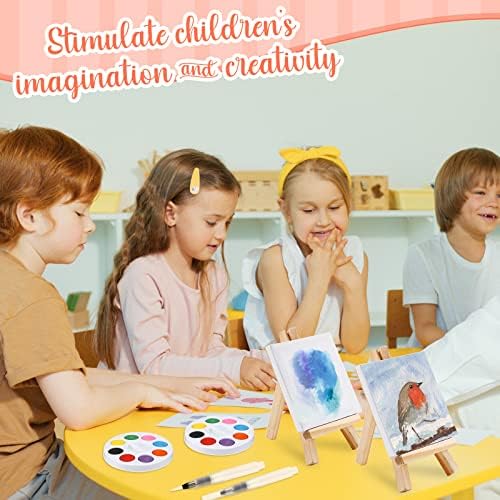 Finished miniature watercolor paintings displayed on tables using the included wooden easel stands