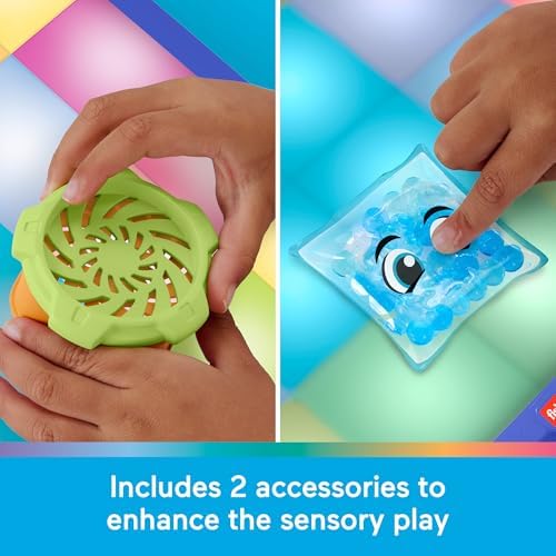 The included interactive spinner and textured goo pack accessories placed on the main surface of the Fisher-Price toy.