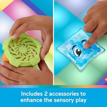 The included interactive spinner and textured goo pack accessories placed on the main surface of the Fisher-Price toy.
