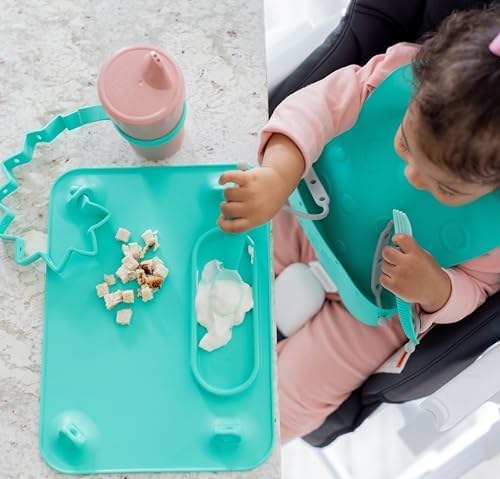 Spearmint Busy Baby silicone mat rolled inside its matching travel sleeve container.