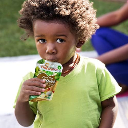Toddler eating HappyTot organic veggie snack pouch on the go