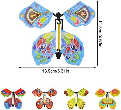 Close up of a hand winding the rubber band mechanism on the wind up butterfly toy
