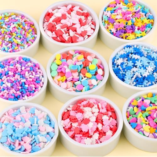 Assorted colorful non-edible polymer clay slices being mixed into clear craft slime.