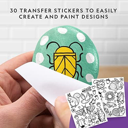 Demonstration of applying the magic transfer decals onto a painted rock using a damp sponge.