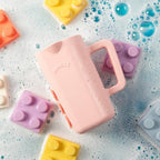 Side angle view of the non toxic BPA free Rinzee silicone baby cup highlighting its ergonomic grip.