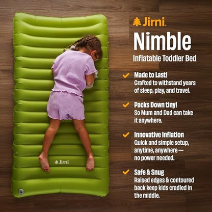 Jirni portable toddler floor bed rolled up compactly next to standard travel luggage.
