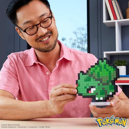 Assembled fifteen centimeter tall pixelated Bulbasaur figure on flat desktop display base