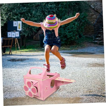 A child wearing the pink cardboard plane costume during an interactive backyard creative play session.