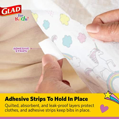 Toddler using Glad for Kids unicorn paper bib during meal
