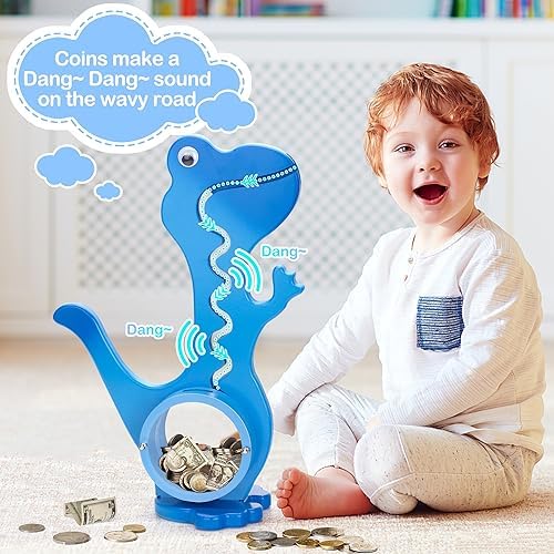 Toddler hands placing a coin into the mouth of the transparent dinosaur savings bank.
