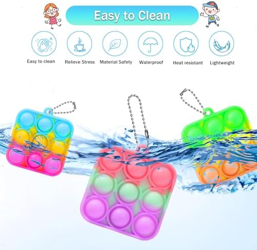 Close up view of a two inch mini pop keychain being pressed by fingers showcasing the flexible food grade silicone material