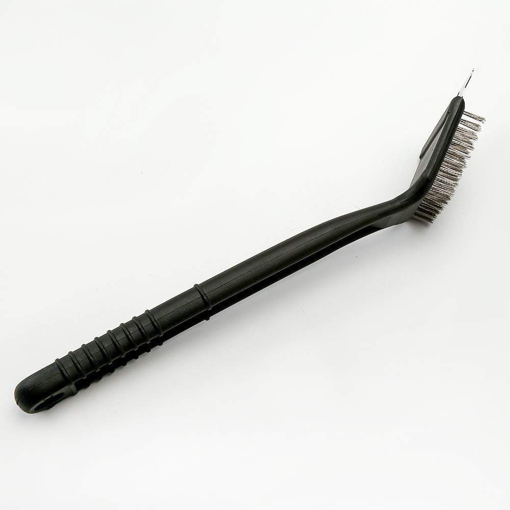 Foiburely bird poop cleaning brush in black color being used to scrub metal pet cage grates.