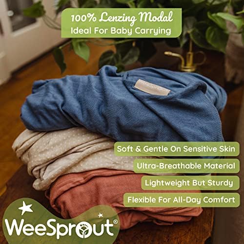 Ergonomic infant carrier wrap supporting a small child securely against caregiver chest.
