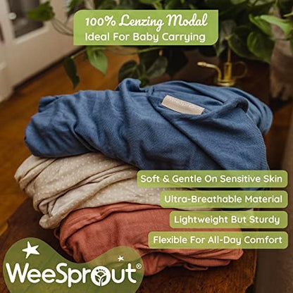 Ergonomic infant carrier wrap supporting a small child securely against caregiver chest.
