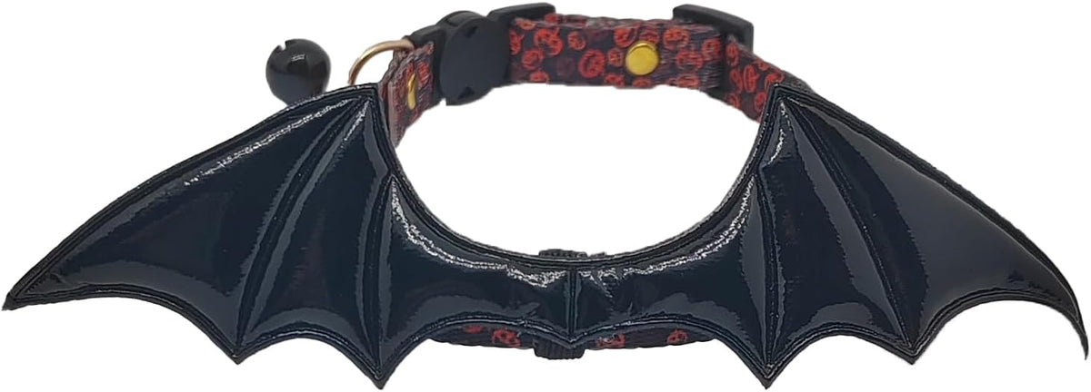 Detailed view of the removable tracking bell attached to the rose colored adjustable breakaway cat collar.