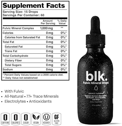 Blk. alkaline water concentrate bottle standing upright next to a clear glass of mineral infused water.