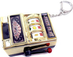Close up view of the manual crank handle and coin slot on the MAGIKON miniature novelty bank.
