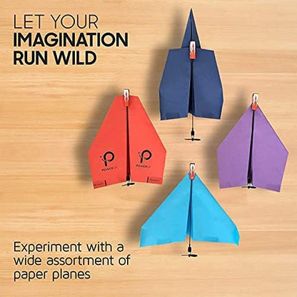 PowerUp 2.0 electric paper plane converter module in action during an outdoor flight launch.