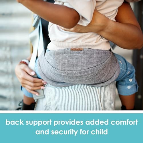 Compact travel baby sling folded neatly next to a diaper bag