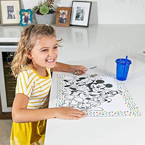 Toddler using the J.L. Childress stick on disposable table mat at a restaurant table.