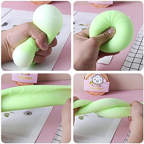 Miniature realistic food steamer desk toy holding a soft stretchy dumpling fidget for office anxiety relief