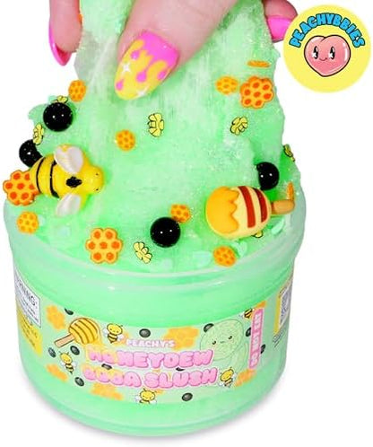 Close up view of the honeydew melon chunk and bee charms included in the Peachybbies kit.