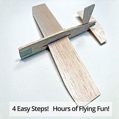 A student launching the lightweight balsa wood toy airplane outdoors during a school STEM competition.