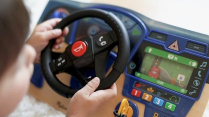 Child playing with screen free sensory toy dashboard illustrating fine motor skill development