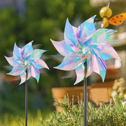 Garden setting featuring multiple reflective wind spinners