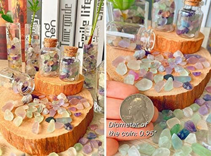 Top down view of Qinjiejie fluorite gemstone chips spread on a surface.