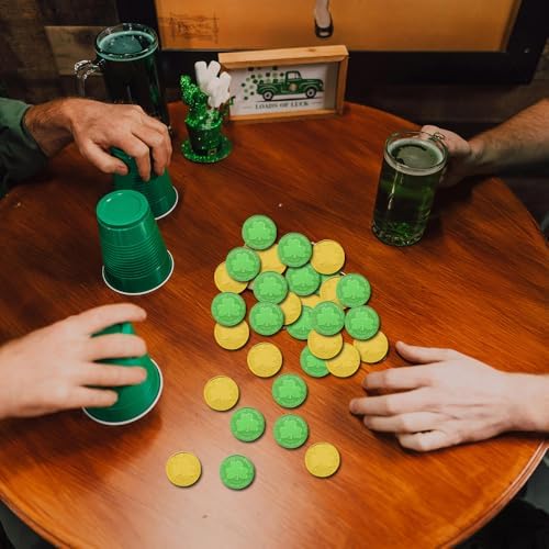 Augsun leprechaun gold and green tokens being held to demonstrate the lightweight plastic material.