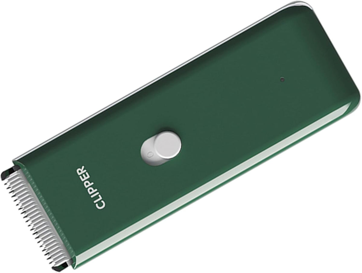 Green waterproof cordless pet hair clippers showing USB charging indicator light