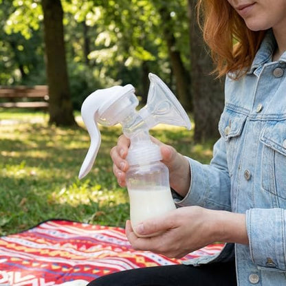 Side angle of the Elfzone white manual breastfeeding pump highlighting the flexible silicone shield