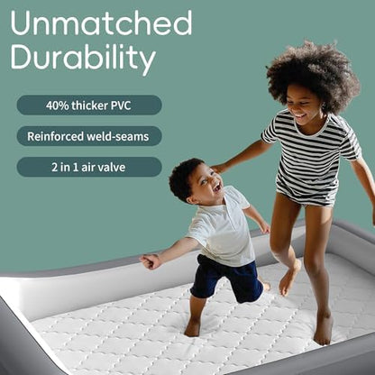 GloTika toddler travel bed with custom soft bed sheet fitted securely over the raised side bumpers.