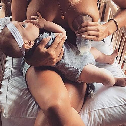Haakaa manual silicone breast pump with the white flower stopper inserted tightly in the neck to demonstrate spill-proof protection.