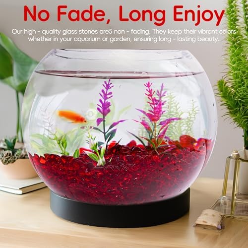 Red aquarium stones inside a small fish bowl