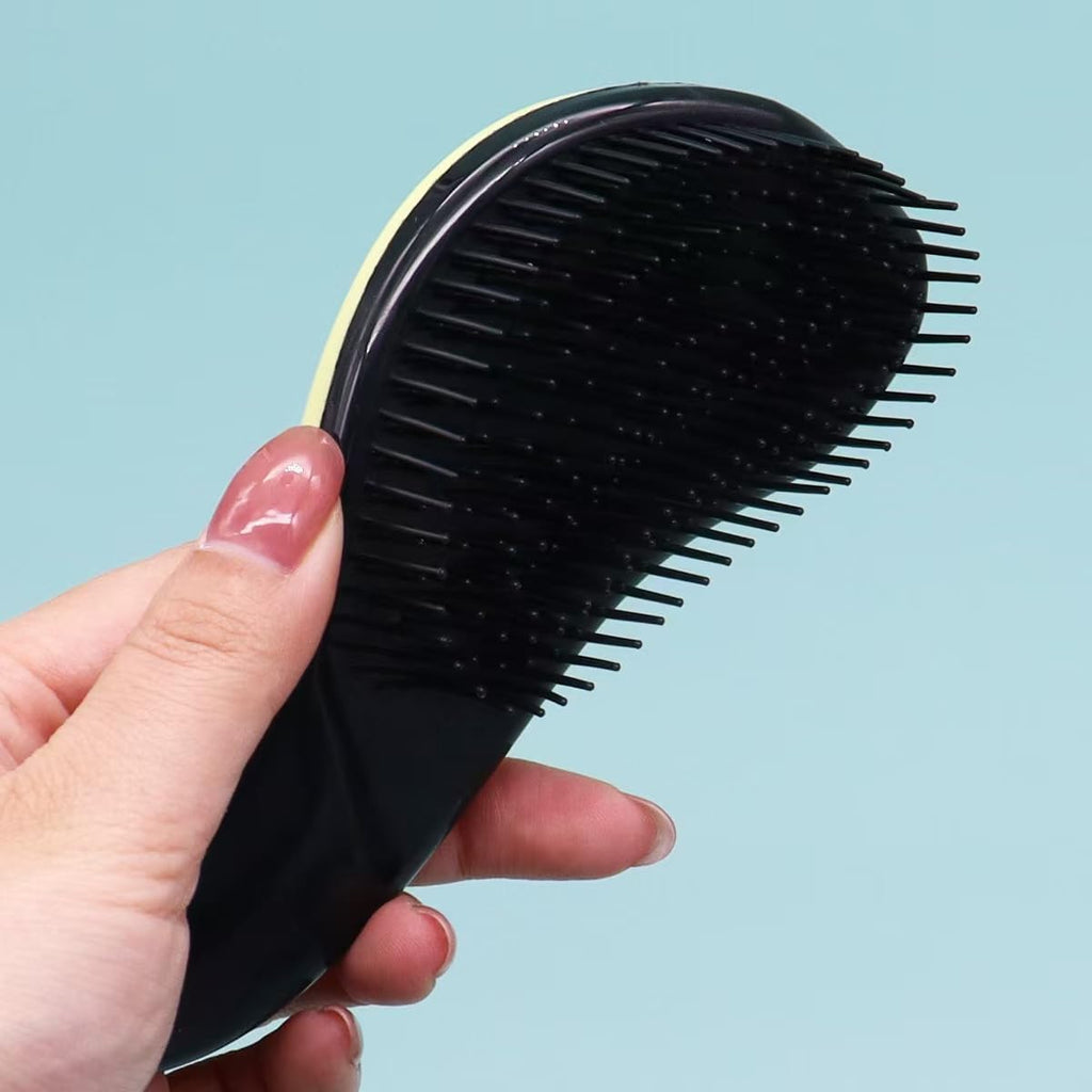 Ergonomic handle detail of the premium pet detangling brush showing flexible bristles.
