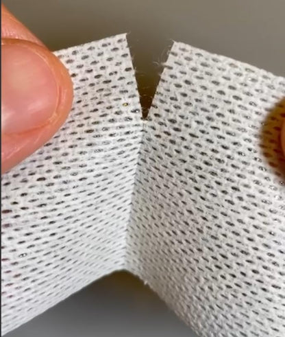 Three rolls of breathable soft fabric cloth surgical tape arranged outside their original box