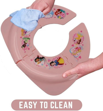 Toddler folding toilet seat being placed into its clear hygienic zip lock storage bag