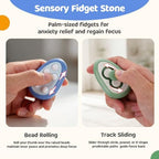 Small Fish pocket sized calming rock held in a hand to demonstrate its discreet size for office stress relief.