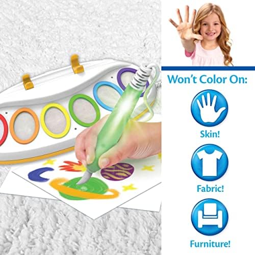 Toddler using the light up brush to paint on clear paper without making a mess