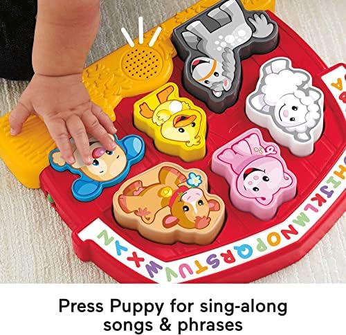 Fisher-Price electronic baby puzzle highlighting the interactive musical Puppy button that plays the alphabet song.