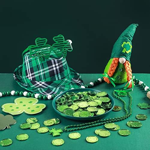 Bulk pile of two hundred pieces green plastic lucky coins scattered on a party table.