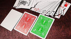 Standard ace of spades and face cards displayed alongside the vibrant green card backs.