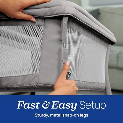 Compact and space saving footprint of the Chicco portable bassinet next to a bed.