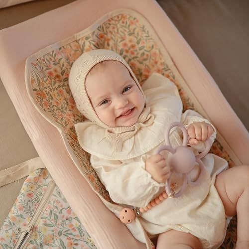 Top view of Mushie changing pad liner on nursery furniture