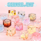 Stacked display of multiple square cat series mystery toys.
